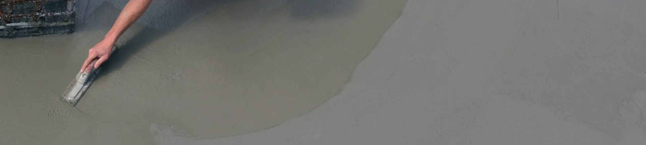 Construction worker smoothing a concrete mix Construction worker smoothing a concrete mix