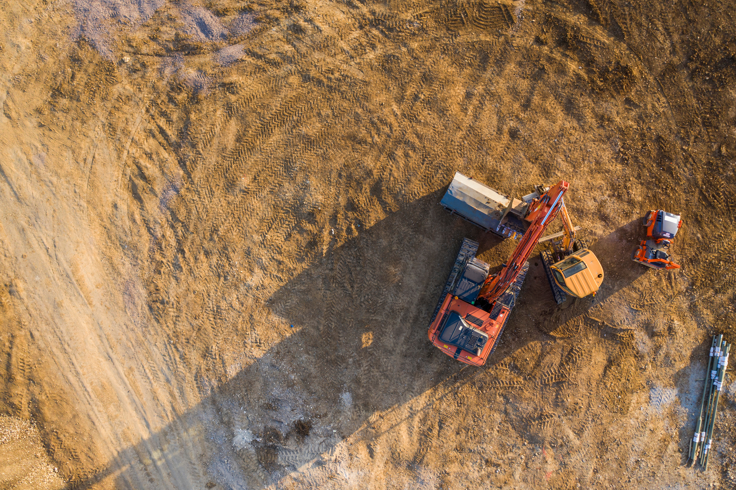 Aerial view of an orange digger at work