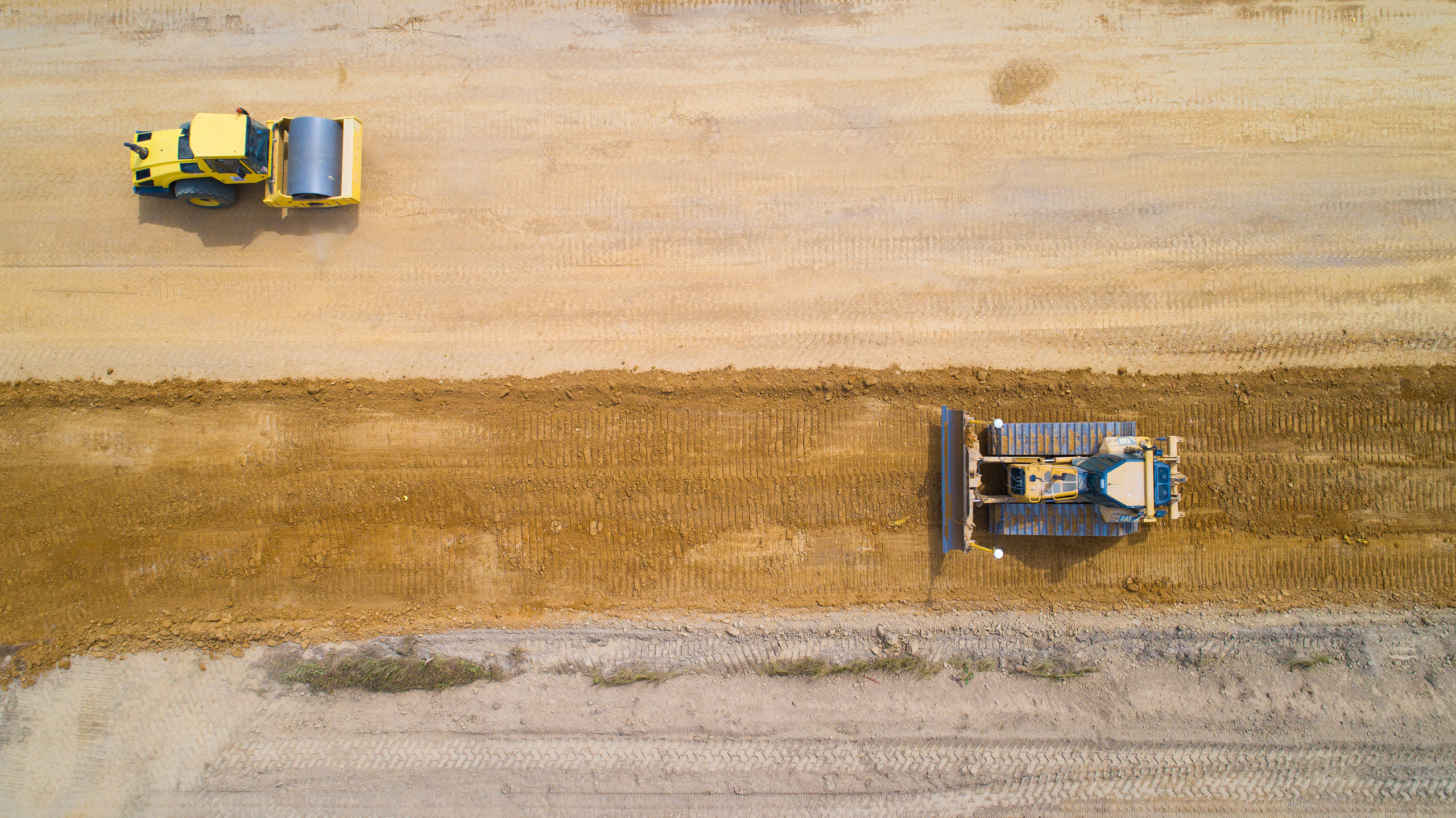 Aerial view of a road being prepared with sand